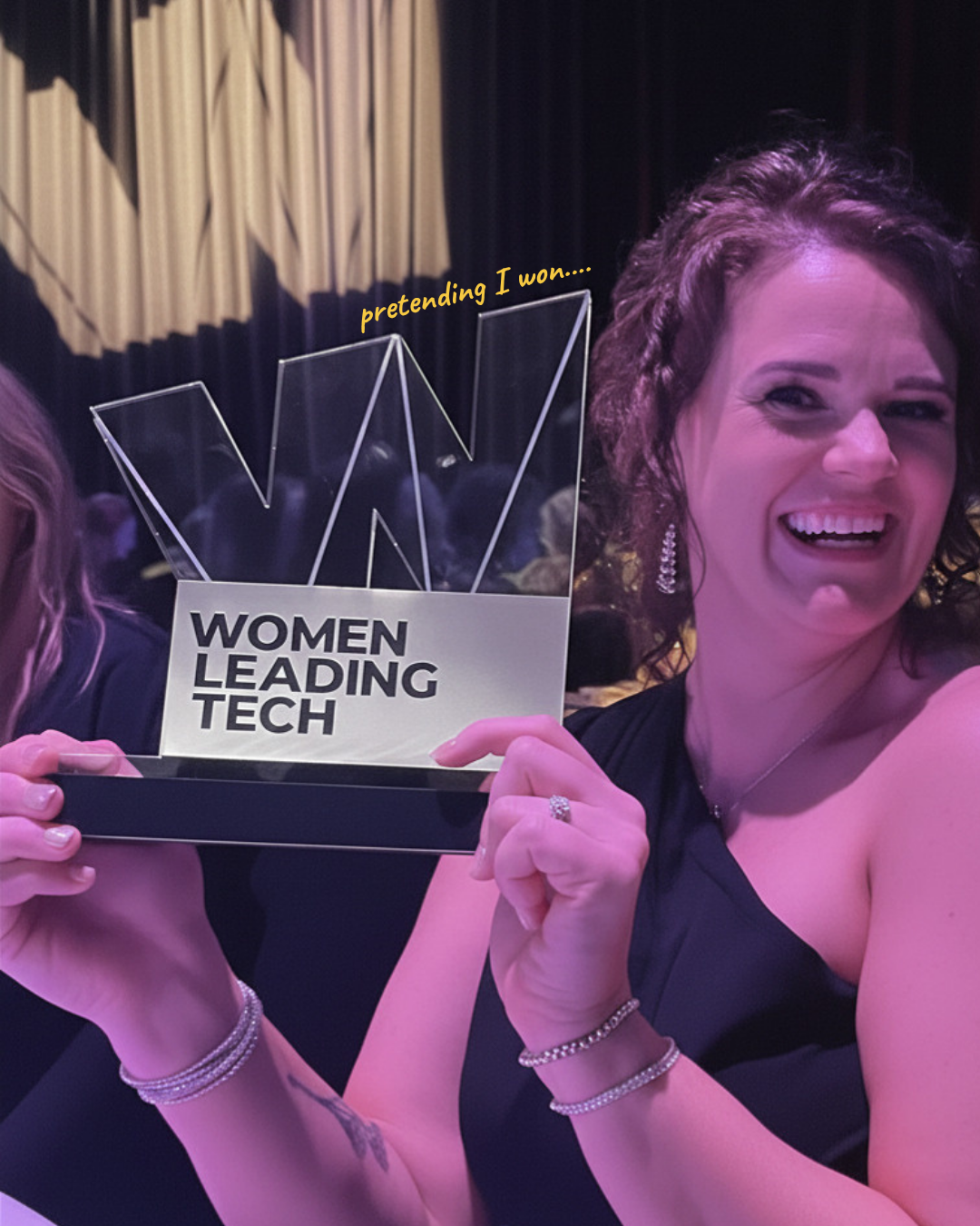 Cheryl holding the Women Leading Tech award trophy at the awards night